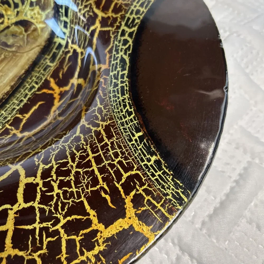 Glass bowl features an asymmetrical shape with a striking black and gold crackle
